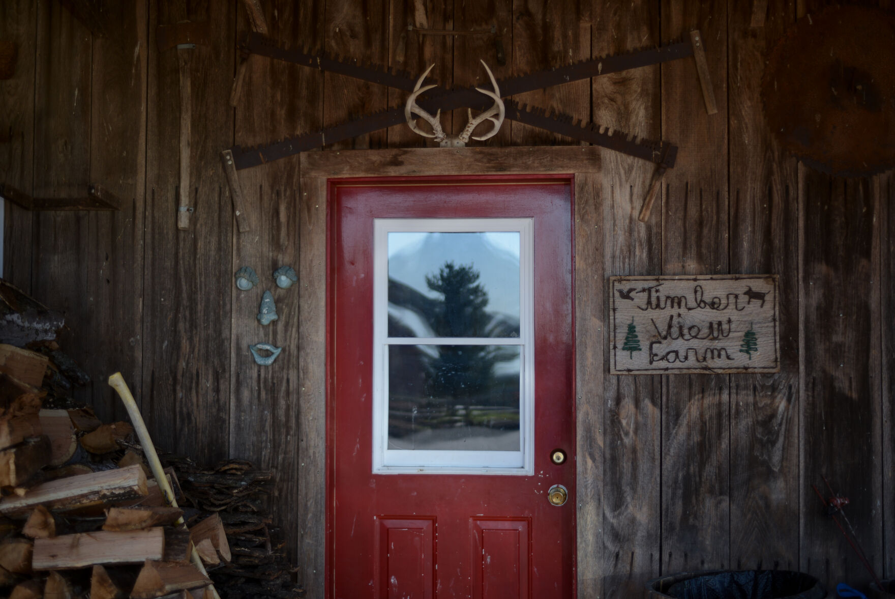 A pile of wood lies next to the entrance of Daryll and Mary Lou Raitts' barn Monday in Hartsburg, Mo.